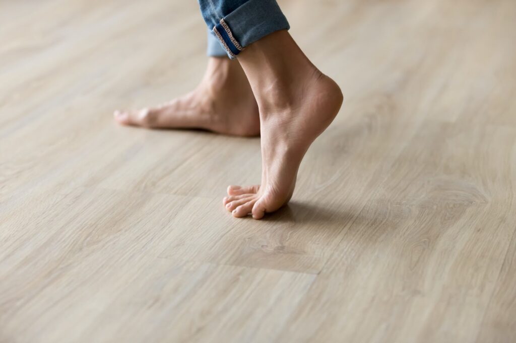 Bare feet on a hardwood floor.