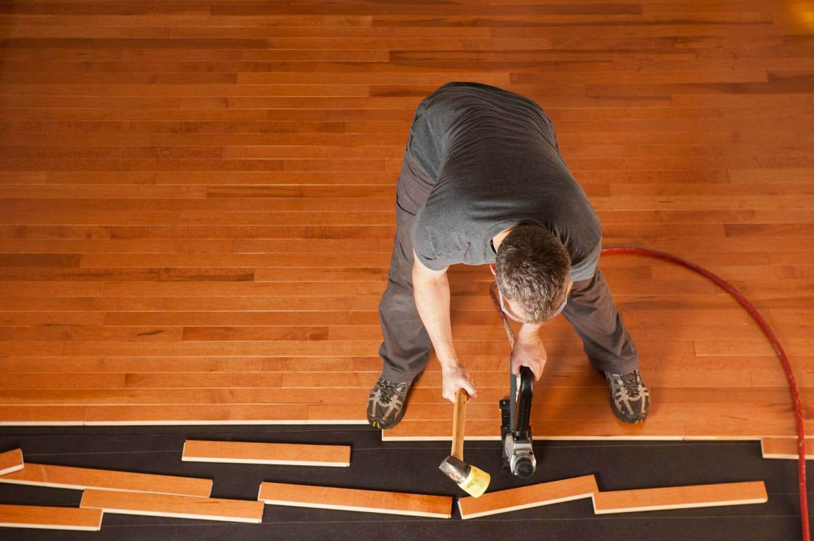 Man installing a new hardwood floor.