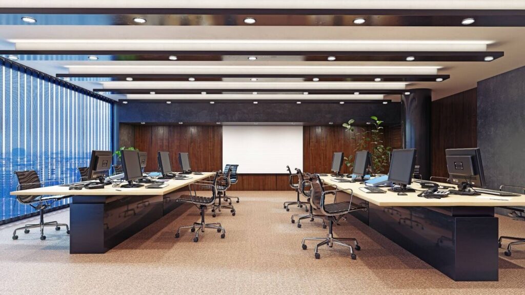 Empty office chairs and computers in a large office.