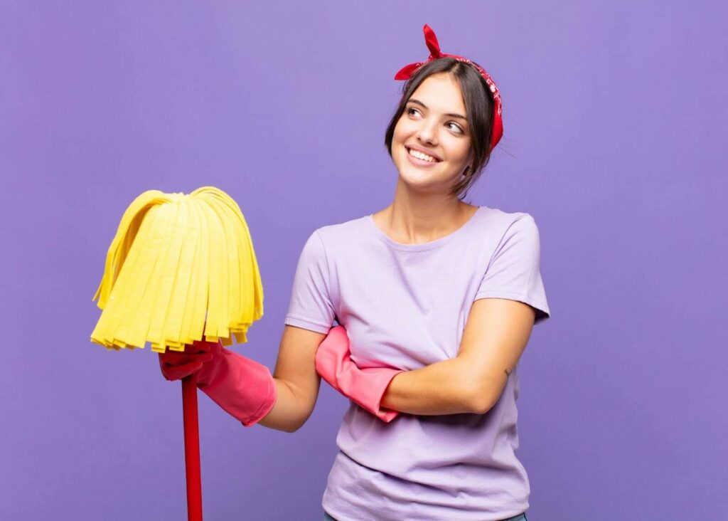 A woman holding a mop